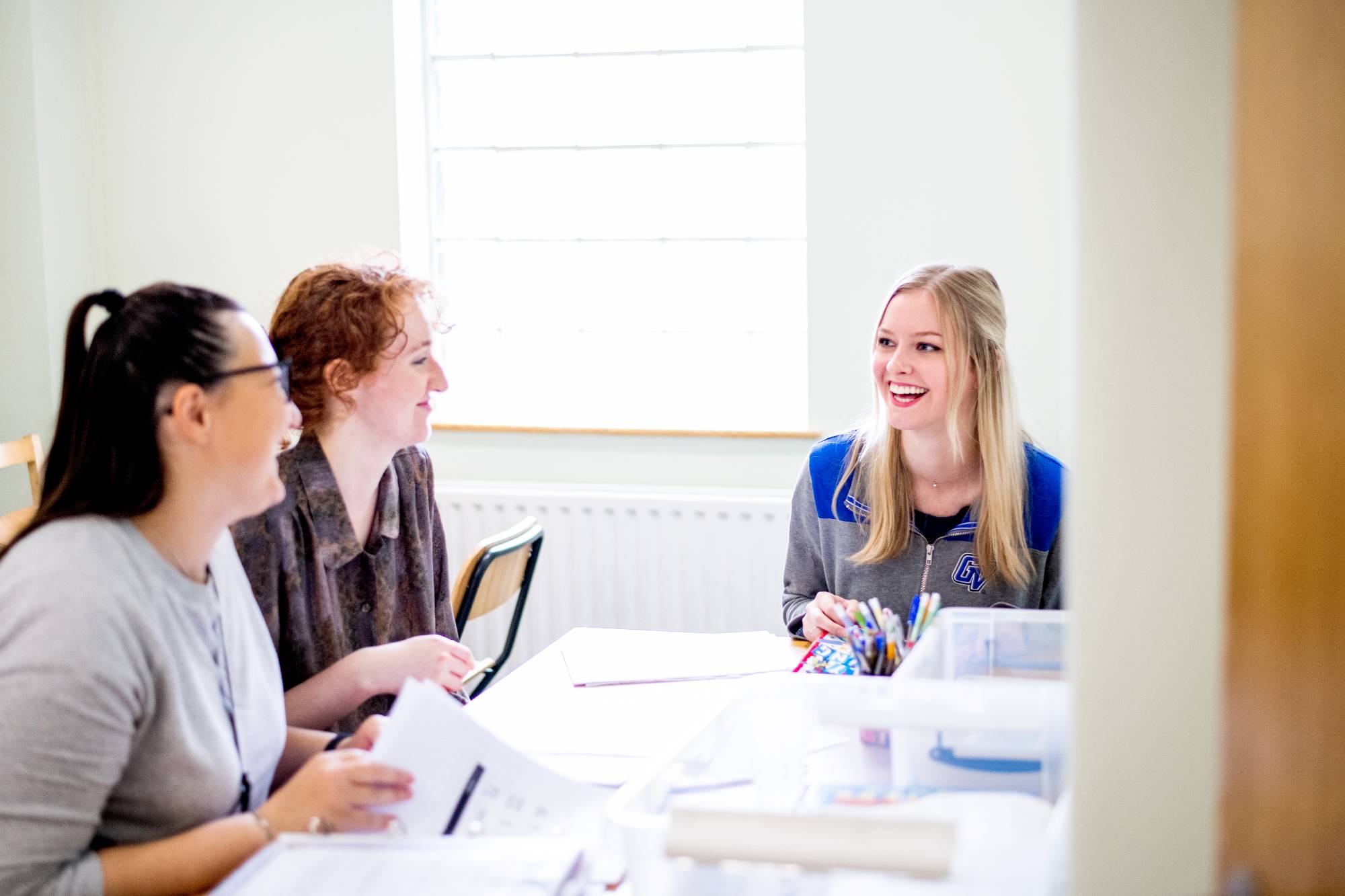 three women taking and laughing